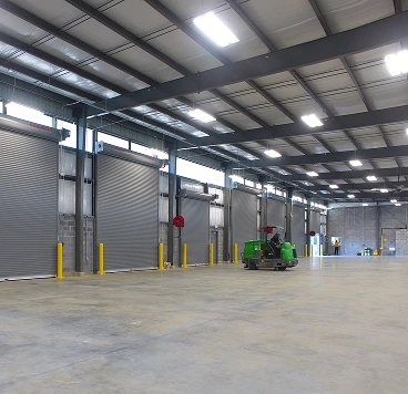 empty warehouse and a green forklift
