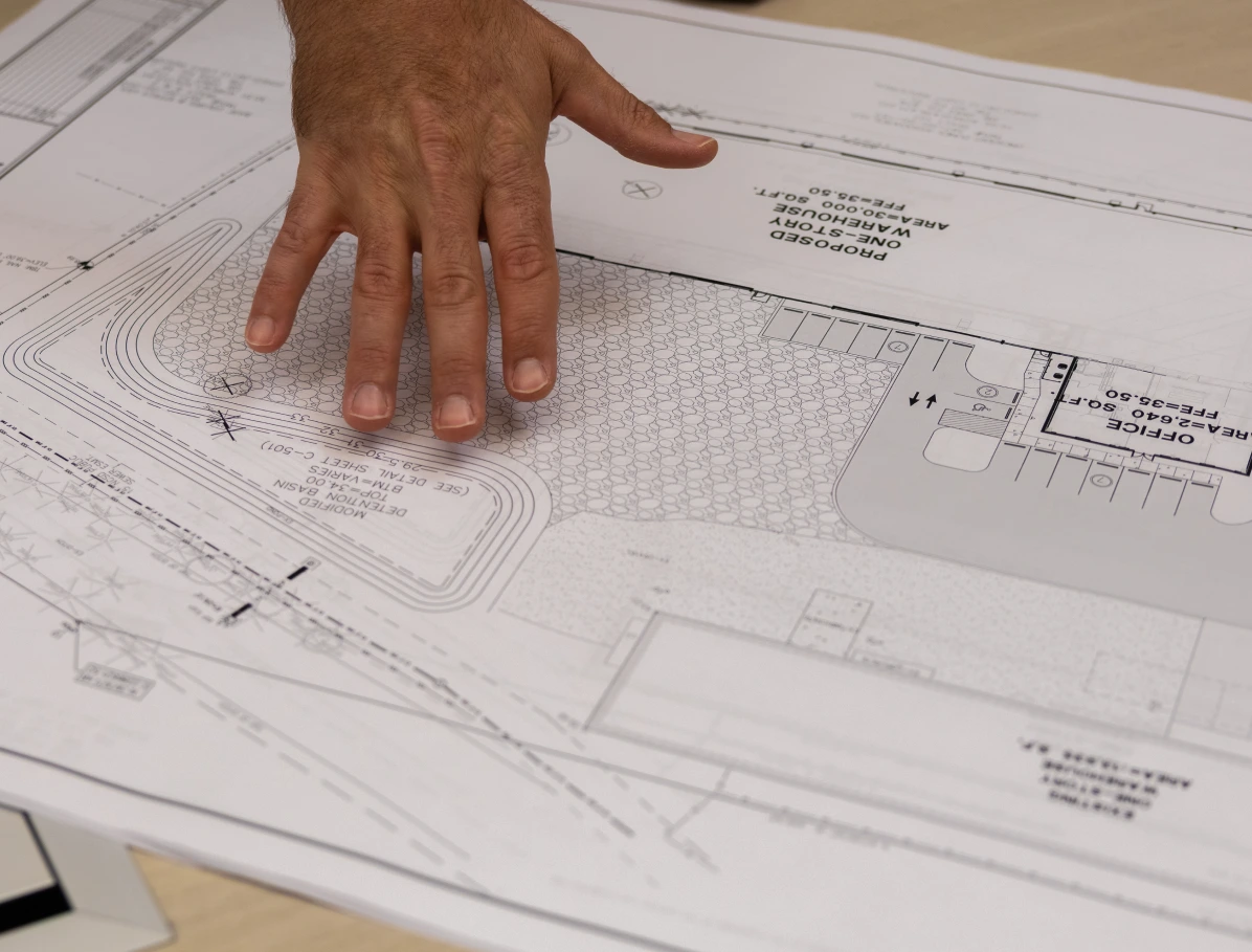 DBC personnel handing out a blueprint