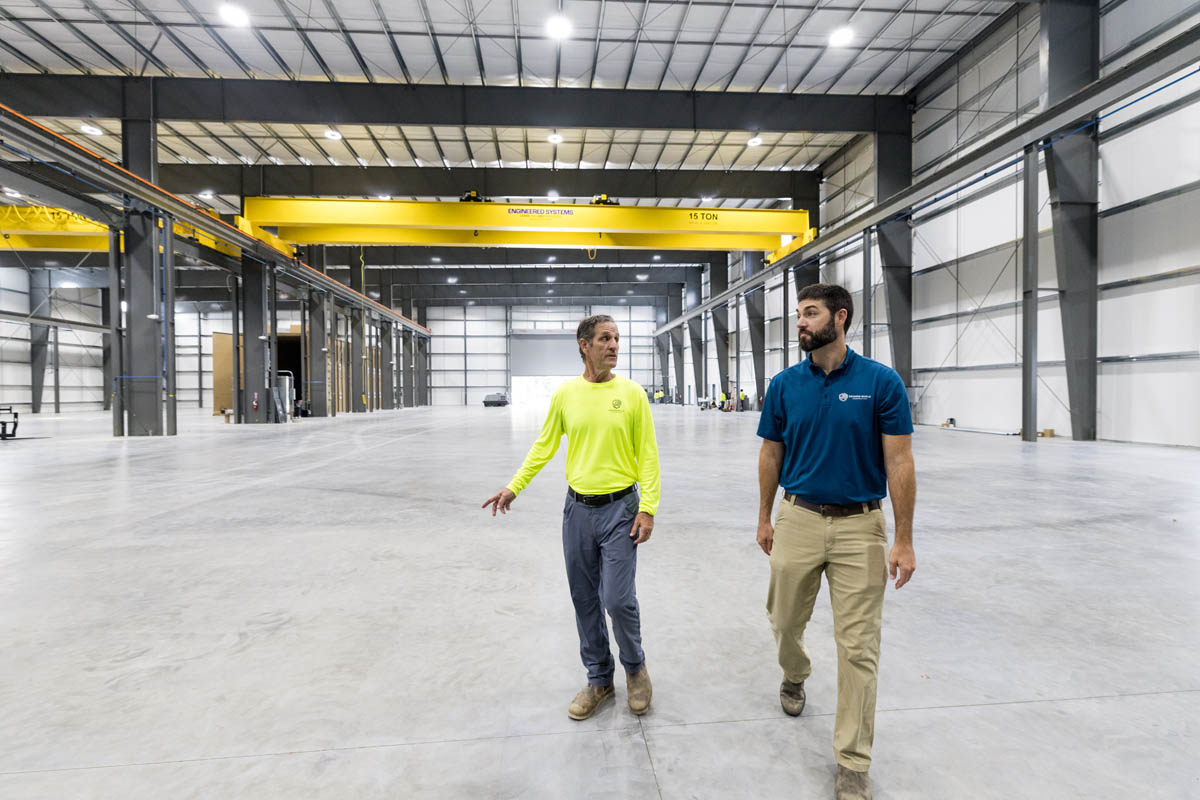 two men inside one of their pre-engineered metal buildings